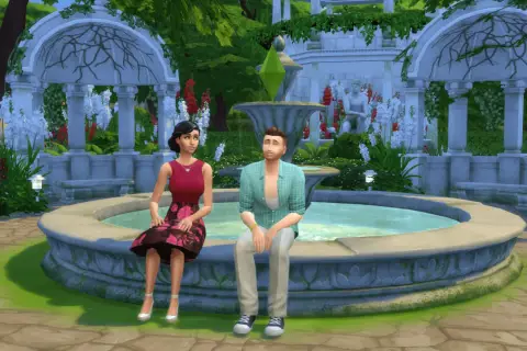 Para dowiedzieć się, jak zmienić relacje między simami w The Sims 4, zobacz tę parę siedzącą przy fontannie w ogrodzie.