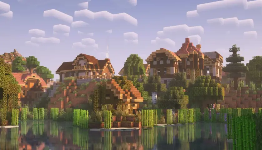 Wioska nad wodą, z domkami z drewna i kamienia, otoczona zielenią. Complementary reimagined shaders nadają jej bajkowy wygląd.