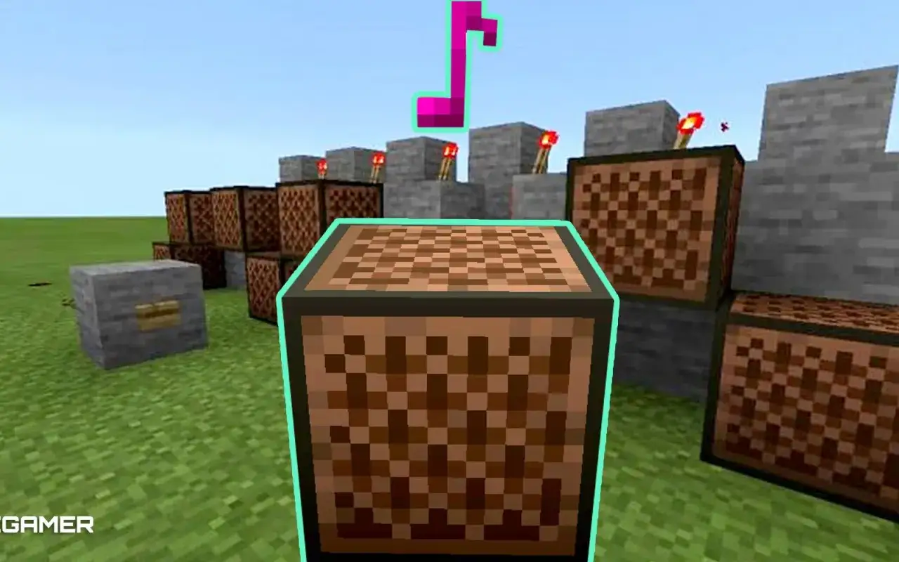 Bloki nutowe w grze Minecraft, gotowe do tworzenia muzyki. W tle widać mechanizmy z redstone i pochodnie.