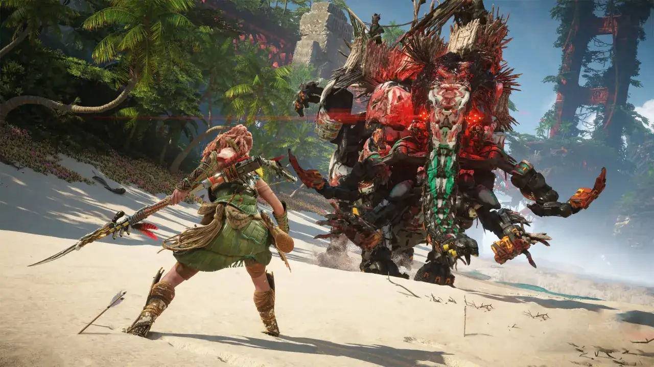 Aloy walczy z mechanicznym potworem na plaży. To scena z Horizon Zero Dawn Remastered.